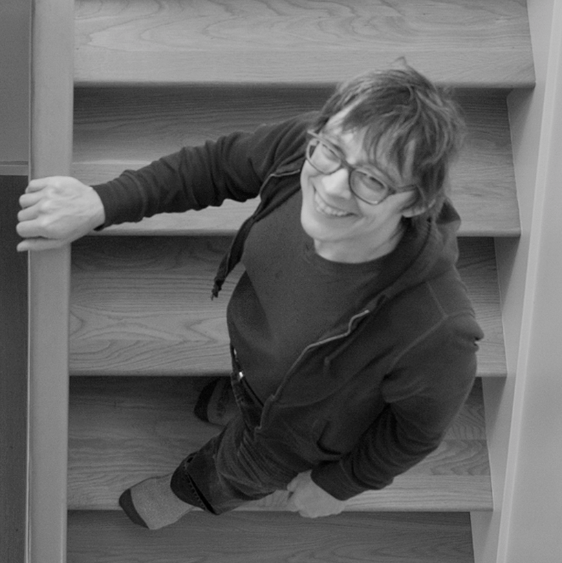 Photo from above of Susasn L Woontan Architect standing in a stairway by Chuck Revell