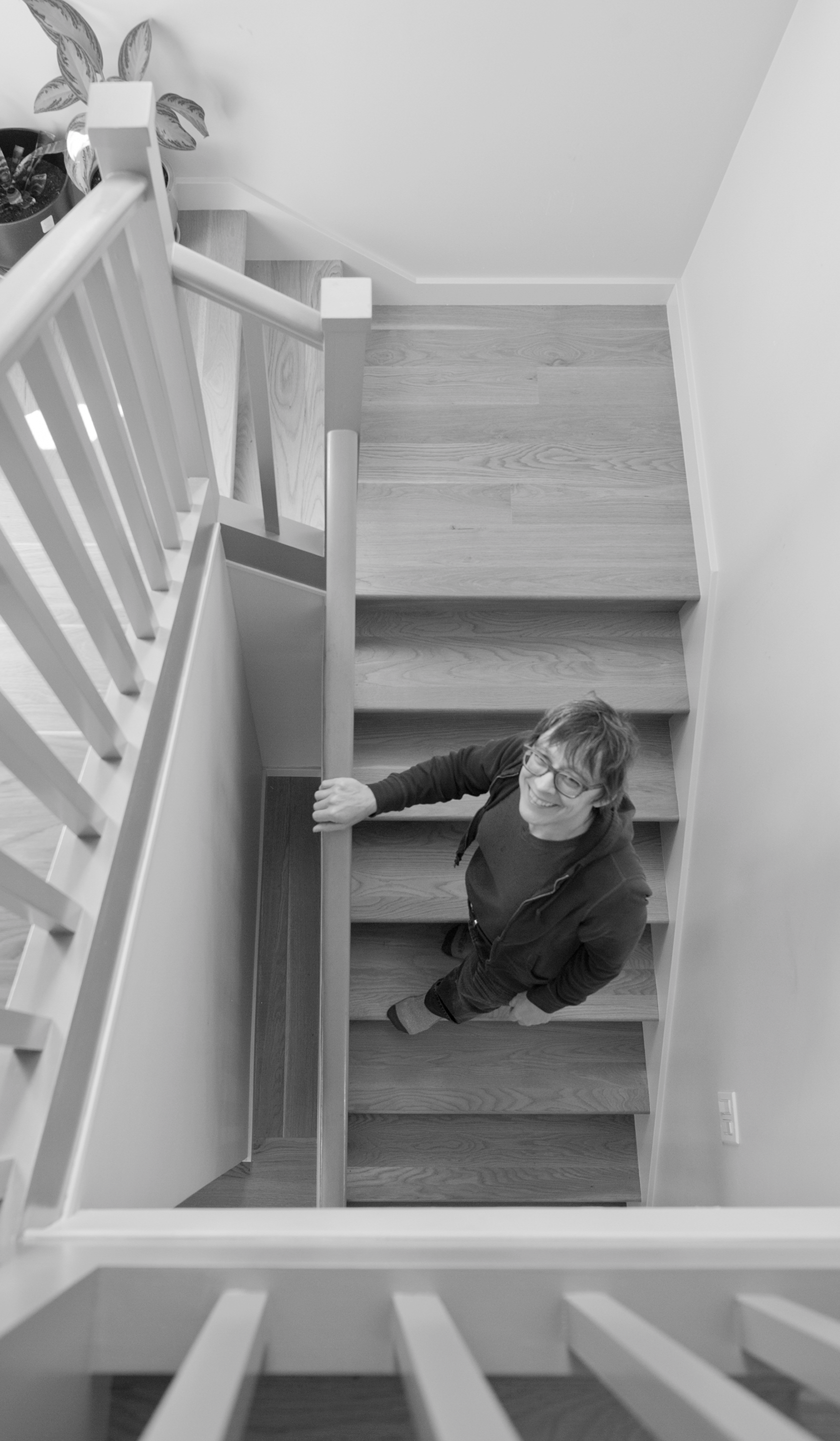 Photo from above of Susasn L Woontan Architect standing in a stairway by Chuck Revell