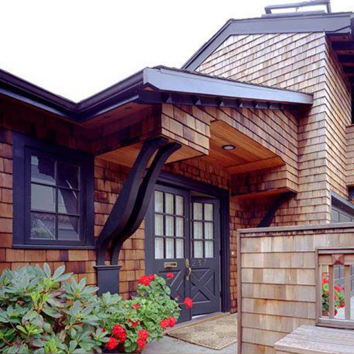 Front entryway with wood shingled sides and dark brown trim. From Facade Renovation in Piedmont, California designed by Susan L. Wootan