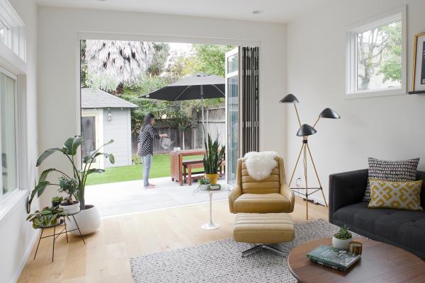 The Berkeley bungalow sliding glass doors open so the living room extends into the back yard