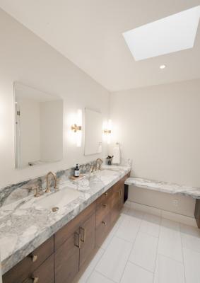 The deluxe master bathroom features a skylight.